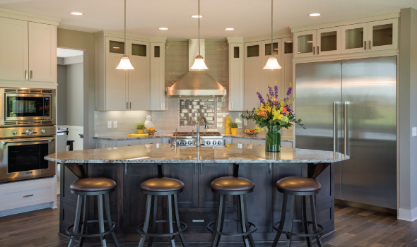 The open kitchen and granite-topped island offer plenty of space for cooking and congregating.