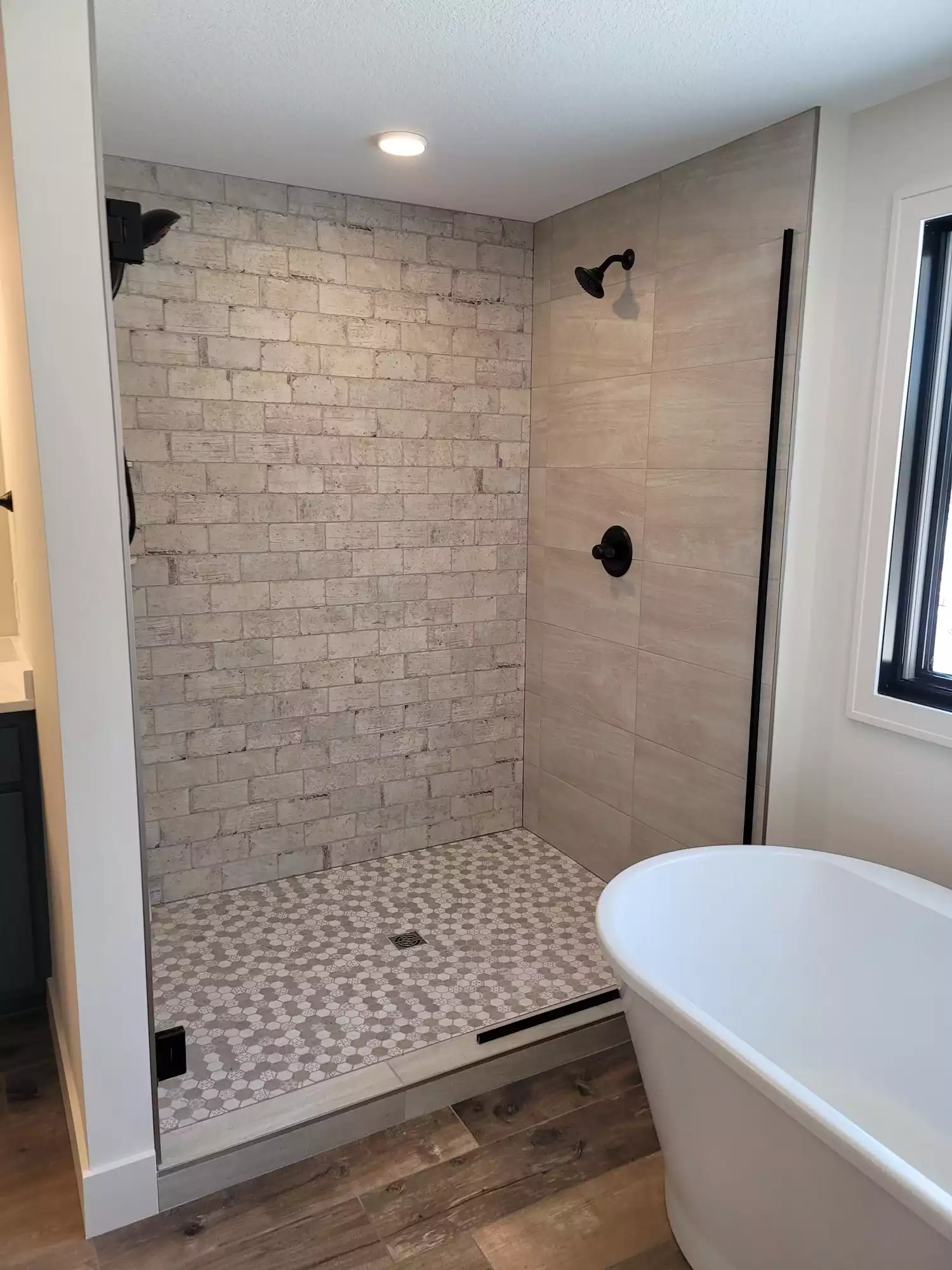 Huge tile and brick shower also free standing tub