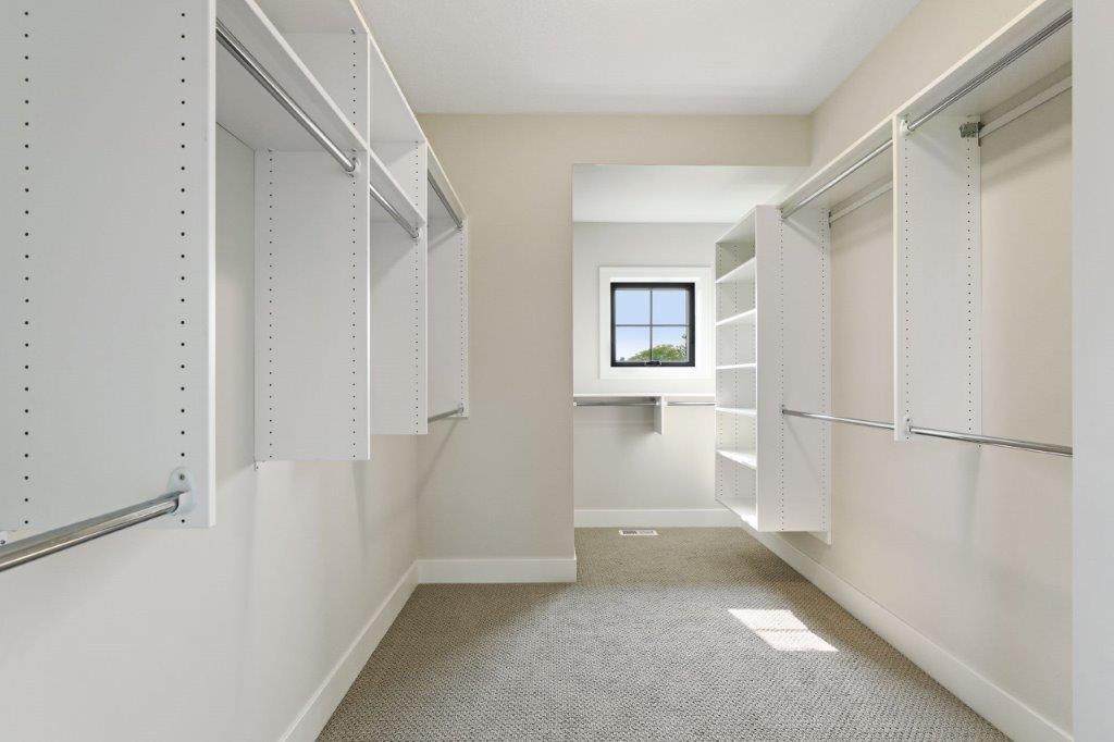 Owners’ ensuite walk-in closet with organizers