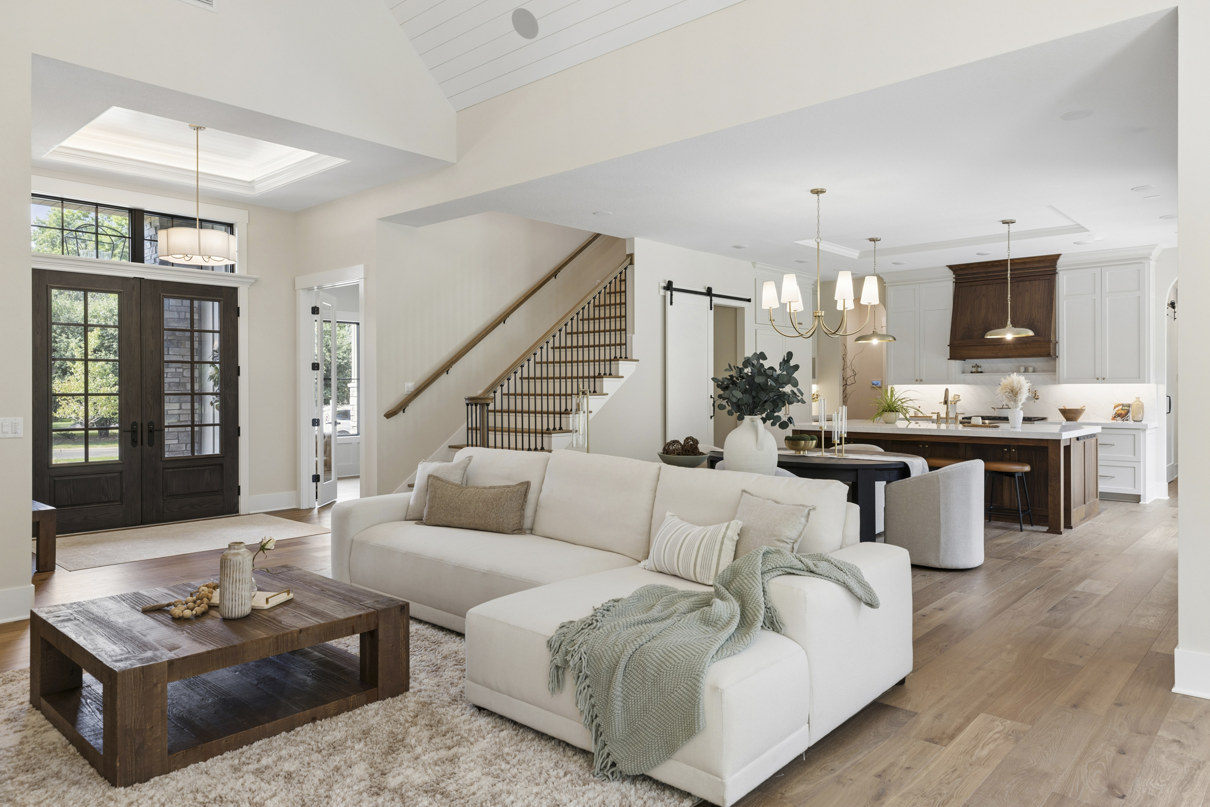 Open-concept interior at 6205 Hillside connecting the great room, dining area, kitchen, staircase, and welcoming front entry.