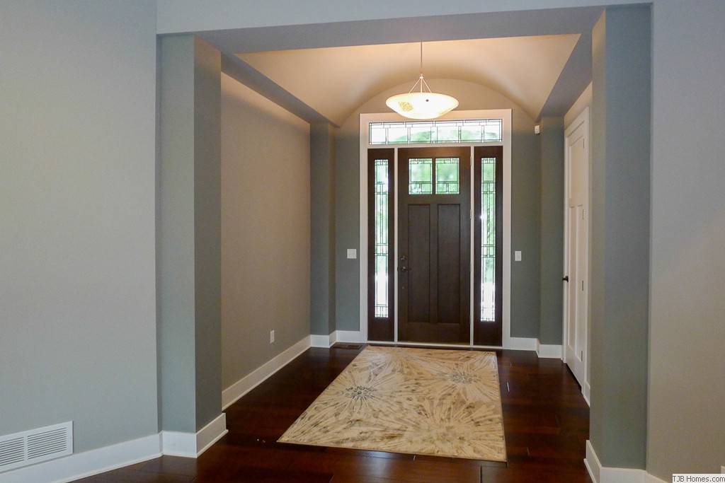 Wood Floor, Decorative Door, Arched Ceiling Foyer